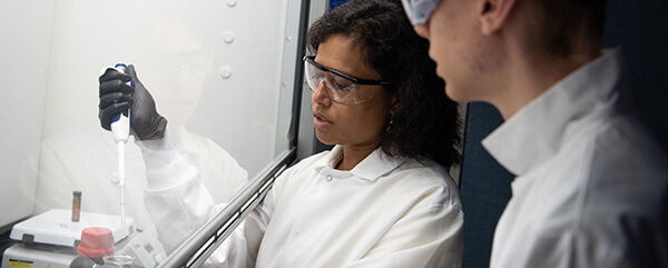 Dr. Mahua Biswas works with student researcher in her lab.