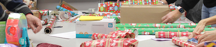 Volunteers working wrapping gifts