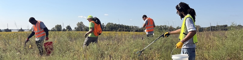 students cleaning up a field