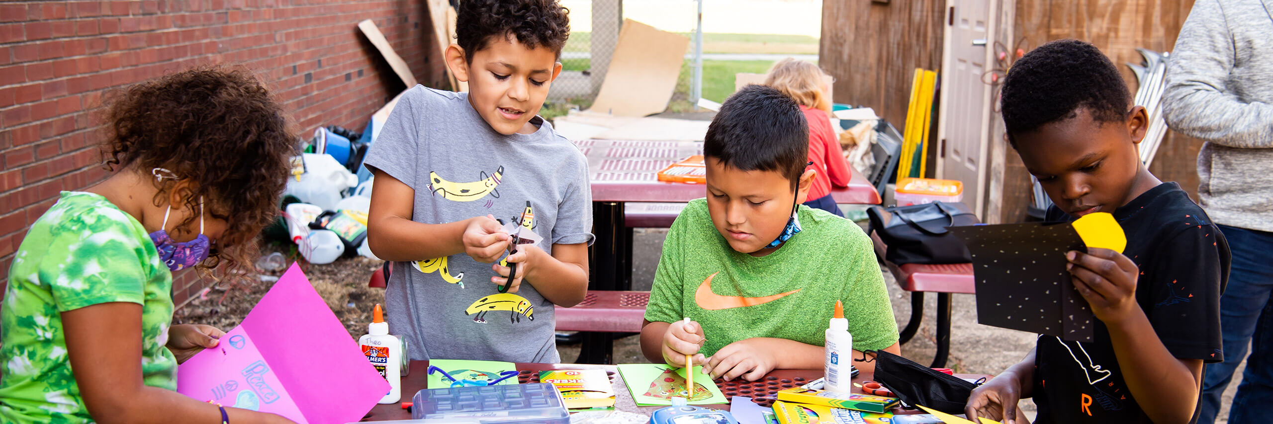 kids participating in the Unity Community Center after-school program doing some painting and other hands-on art activities.